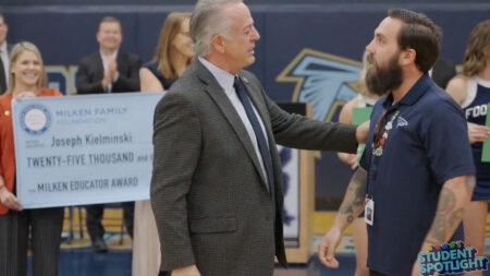 Joseph Kielminski, a Foothill High School special education teacher, is greeted by Governor Joe Lombardo.